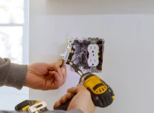 worker installing electrical outlet